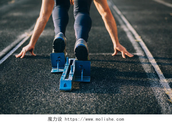 运动会黑色橡胶跑道上运动员蹲踞式起跑准备起跑图励志运动健身户外跑步